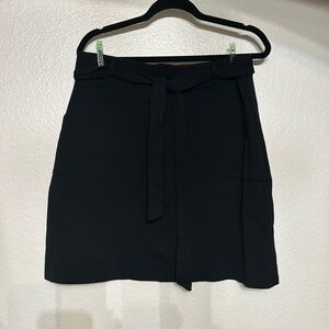 GILLI, black knee length stretchy pencil skirt with pockets and belt. Size XL